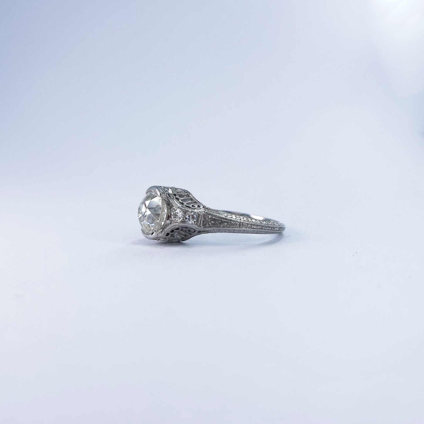 1920s Platinum Filigree Ring with Bezel Set Diamond