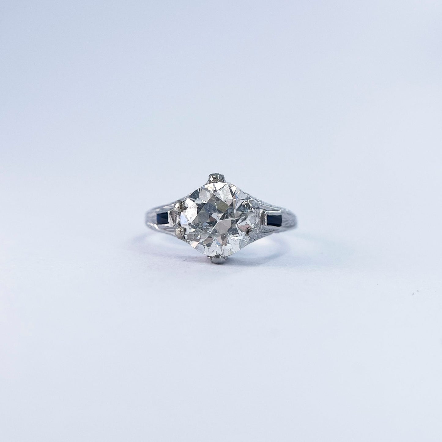 1920s Art Deco Old European Round Cut Diamond and French Cut Sapphire Ring in 20K White Gold